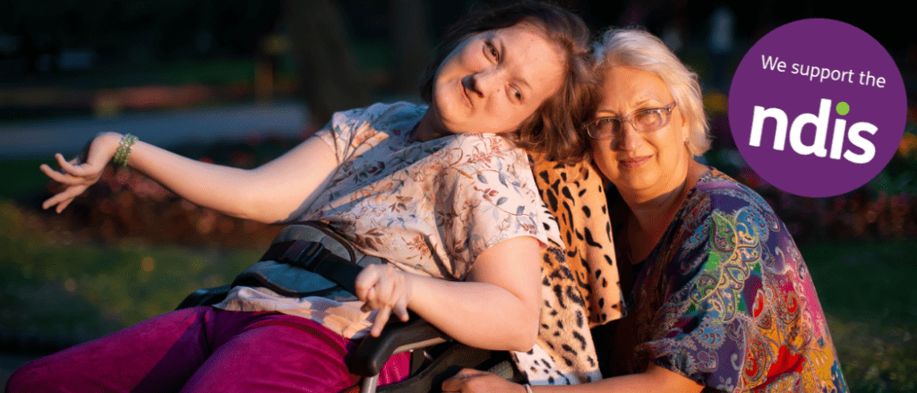 A young woman in a wheelchair with her mother